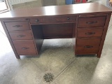 Solid wood desk; seven drawers.