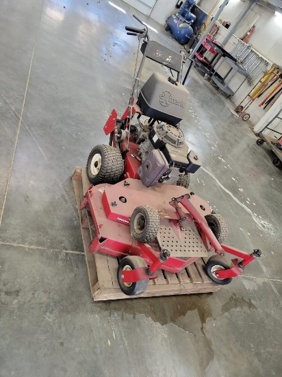 Exmark walk beind commercial mower with stand-on dolly