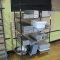 wire shelving unit on casters full of stainless meat trays
