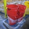 pallet of red Rubbermaid Brute trash cans