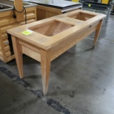 wooden table w/ holes cut out in top