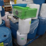 pallet of plastic barrels, eye wash station & heat seal machine