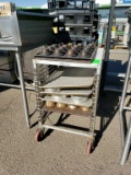 Stainless pan dolly with sheet pans and cake trays