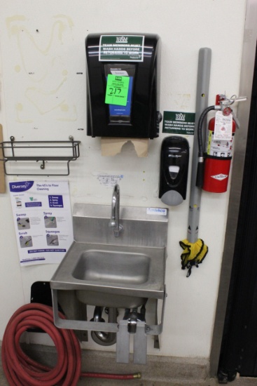 Stainless sink with paper towel and soap dispenser