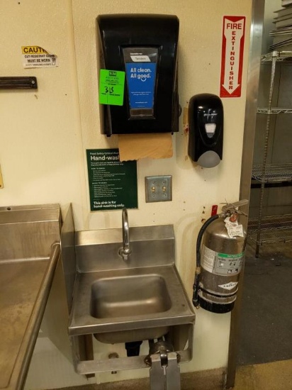 Stainless sink with paper towel and soap dispenser