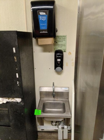 Stainless sink with paper towel and soap dispenser