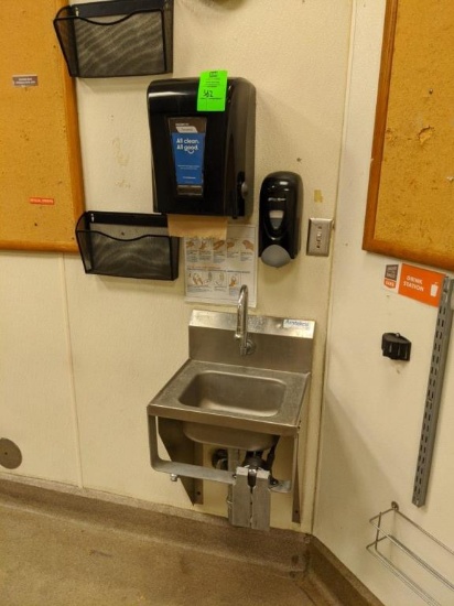 Stainless sink with paper towels and soap