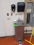 Stainless sink with paper towel and soap dispenser