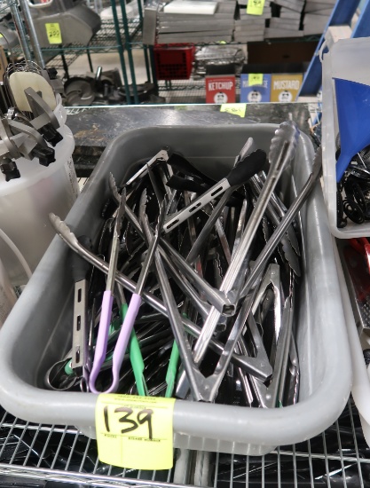 tub of assorted tongs