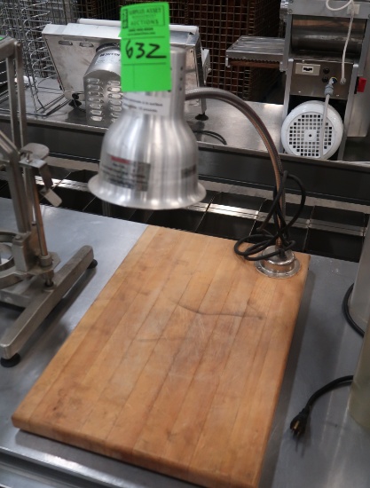 heat lamp on butcher block board