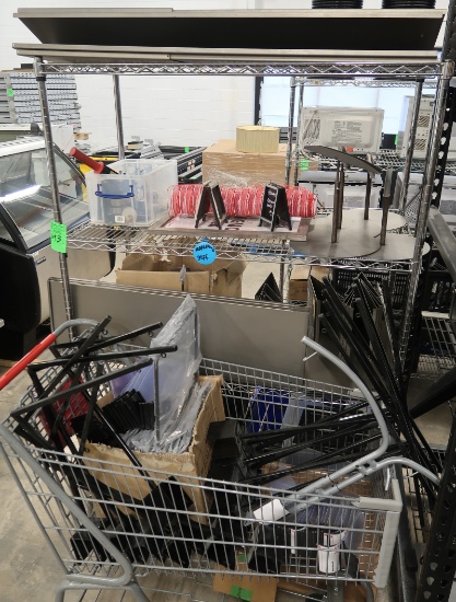 wire shelving unit & shopping cart full of sign holders & marketing paraphernalia