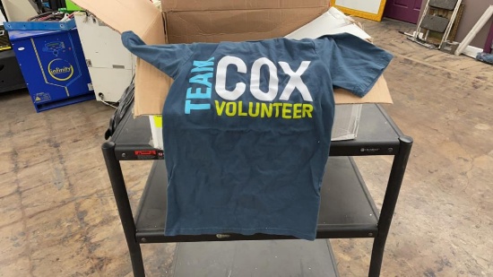 Box of team Cox volunteers Tshirts