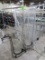 garment racks, one missing a wheel