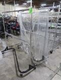 garment racks, one missing a wheel