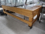 wooden merchandising table, on casters