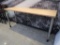 wooden table w/ steel legs, on casters