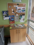 wooden cabinet w/ granite top & bulletin board
