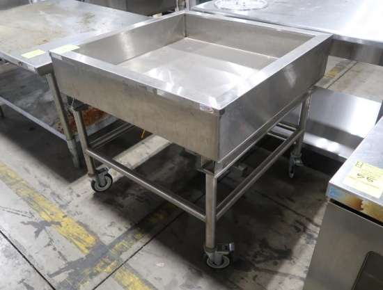 stainless iced product merchandiser w/ variable angle, drain, & casters