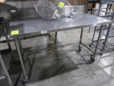 stainless table w/ backsplash, on casters