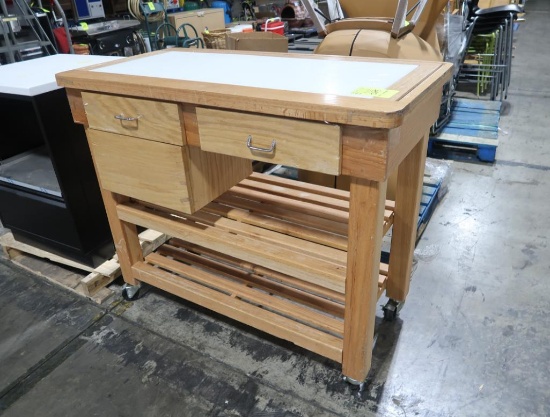 wooden table w/ poly in top center, & drawers, on casters