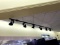 BLACK TRACK LIGHT ABOVE FLORAL CASE
