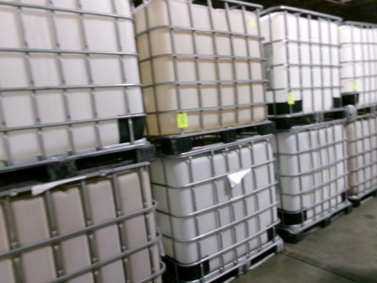 Large plastic liquid containers with dispenser valve in metal frame