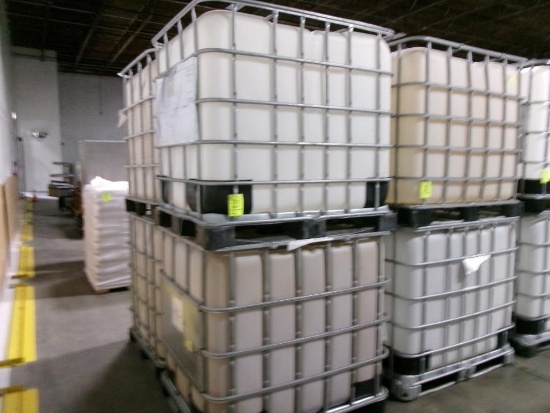 Large plastic liquid containers with dispenser valve in metal frame