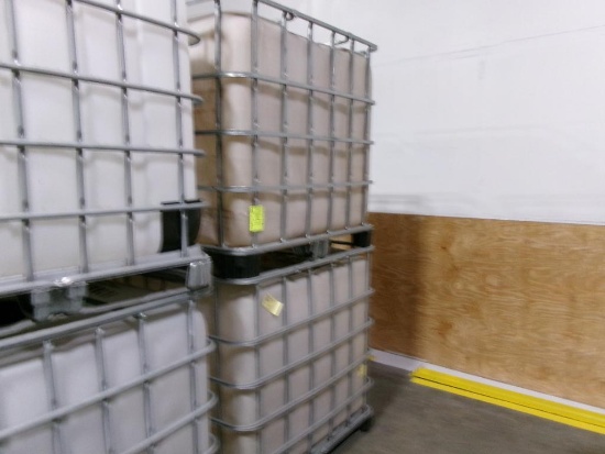 Large plastic liquid containers with dispenser valve in metal frame