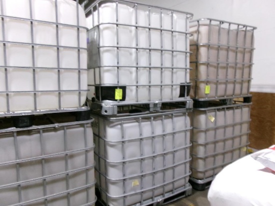 Large plastic liquid containers with dispenser valve in metal frame