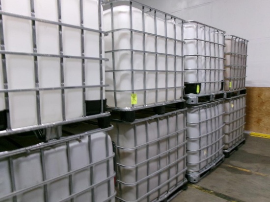 Large plastic liquid containers with dispenser valve in metal frame