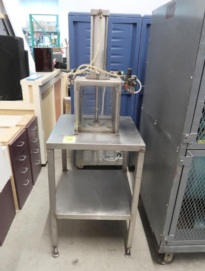enclosed hydraulic press, mounted on stainless table