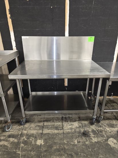 4' STAINLESS STEEL TABLE ON CASTERS W/ 15 1/2 BACK SPLASH