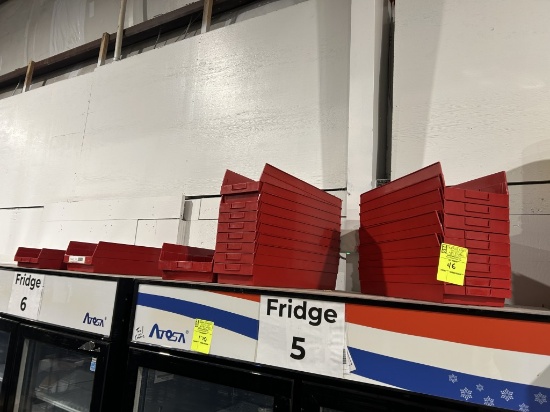 GROUP OF PLASTIC ORGANIZING BINS ON COOLERS