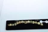 10 KT GOLD CHARM BRACELT WITH 10 - 10KT CHARMS & 2 UNMARKED, 40 GTW,