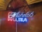 Michalob Ultra beer sign (note neon tubes light by partially dim)