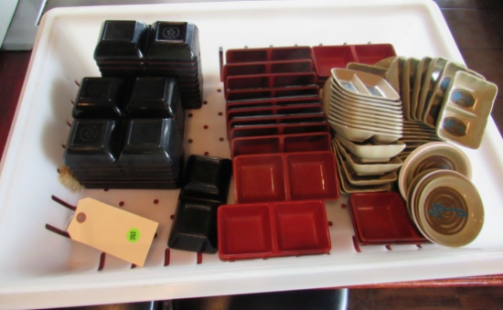 mixed lot of sauce dishes with plastic strainer busing tray