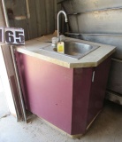 hand wash sink in wood cabinet