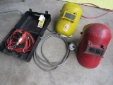 pair welding helmets, jumper cables, Masterlock lock cable (no key for lock shown on the cable)