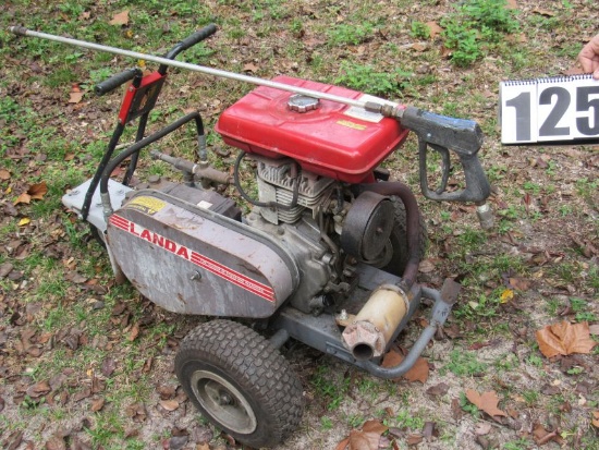 portable gasoline powered magnum pressure washer mounted on cart.  Hoses, and spray gun included