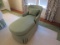 green fainting sofa with mathing pillos