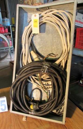 open electrical panel box with partial roll of romex and single ph heavy duty extension cord