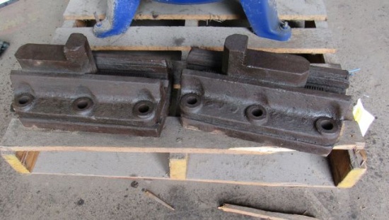 pair adjustable jaws typically used for large lathe face plates or vertical mills