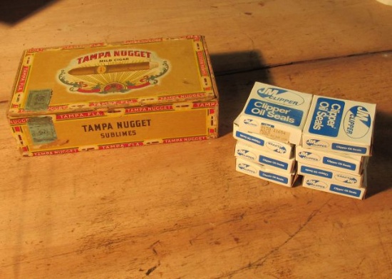 NOS JM Clipper oil seals 015011654 in a Have-A-Tampa cigar box
