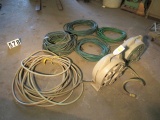 group of water hoses and 2 hose reels with hoses