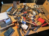 large assortment of tools including box of ear plugs, hammers, chisels, hatchet, saw blades, C-clamp