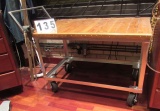 steel framed work table on casters with small vise and varnished wood top