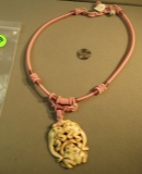 Pink silk corded necklace w/3 frog bone pendant