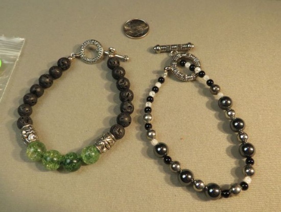 7 1/2" bracelets - 1-lava & green glass bead & 1- onyx & crystal - toggle clasps