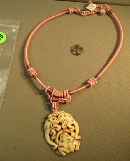 Pink silk corded necklace with pendant of 3 frogs carved from bone