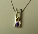 Sterling pendant w/2 c.z. (dark yellow & purple) on 16
